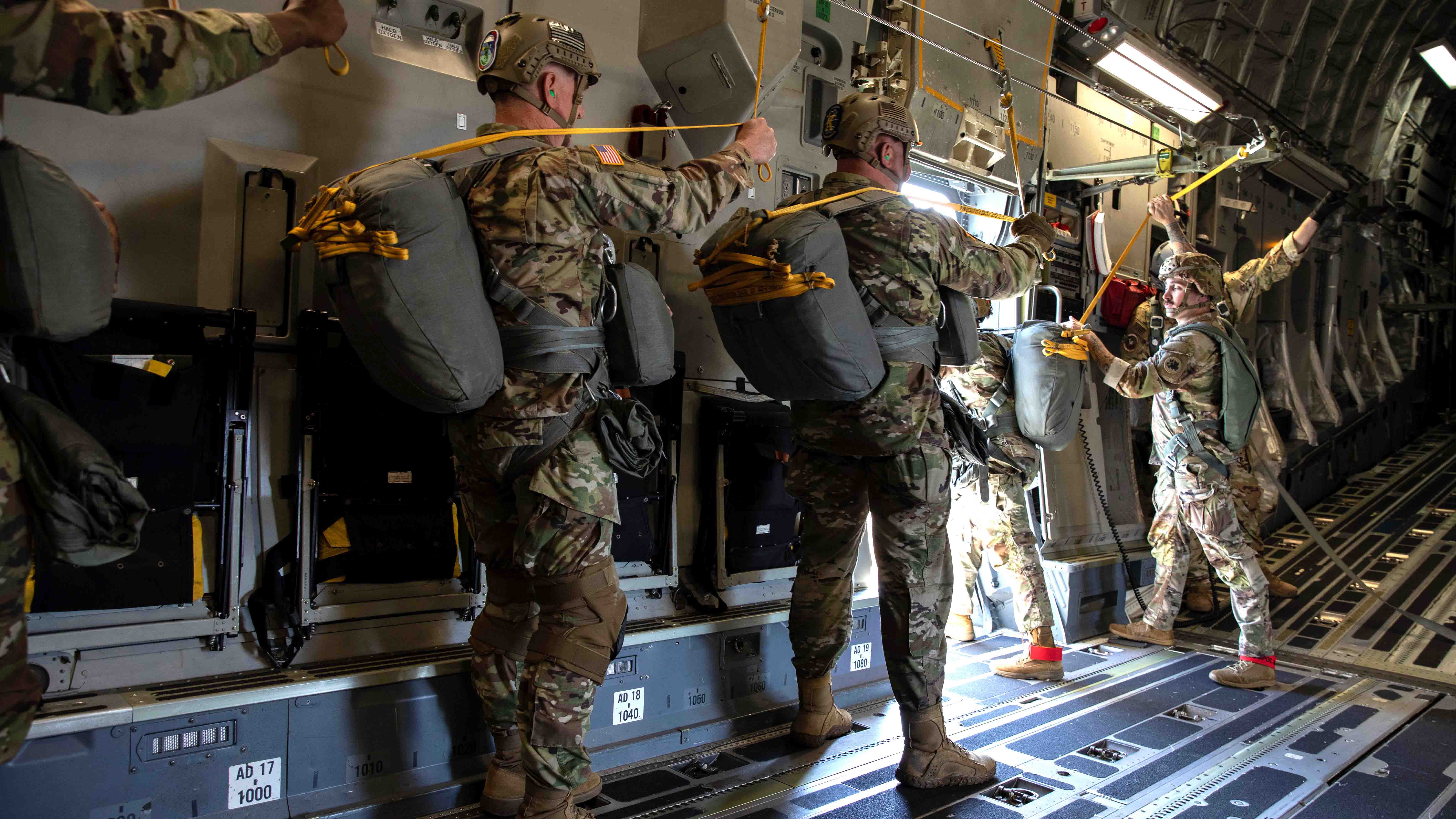 U.S. Army Soldiers with the 165th Quartermaster Company, 78th Troop Command, Georgia Army National Guard, wait for their turn to conduct static line airborne jumps out of a C-17 Globemaster III cargo airplane