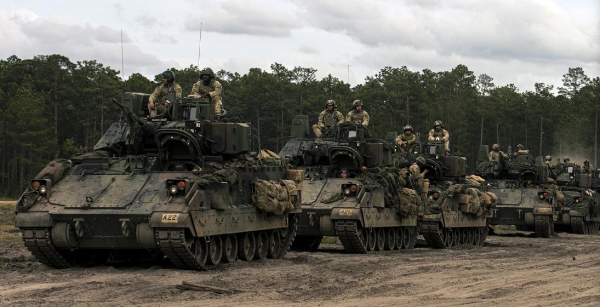 Soldiers on vehicles in a convoy