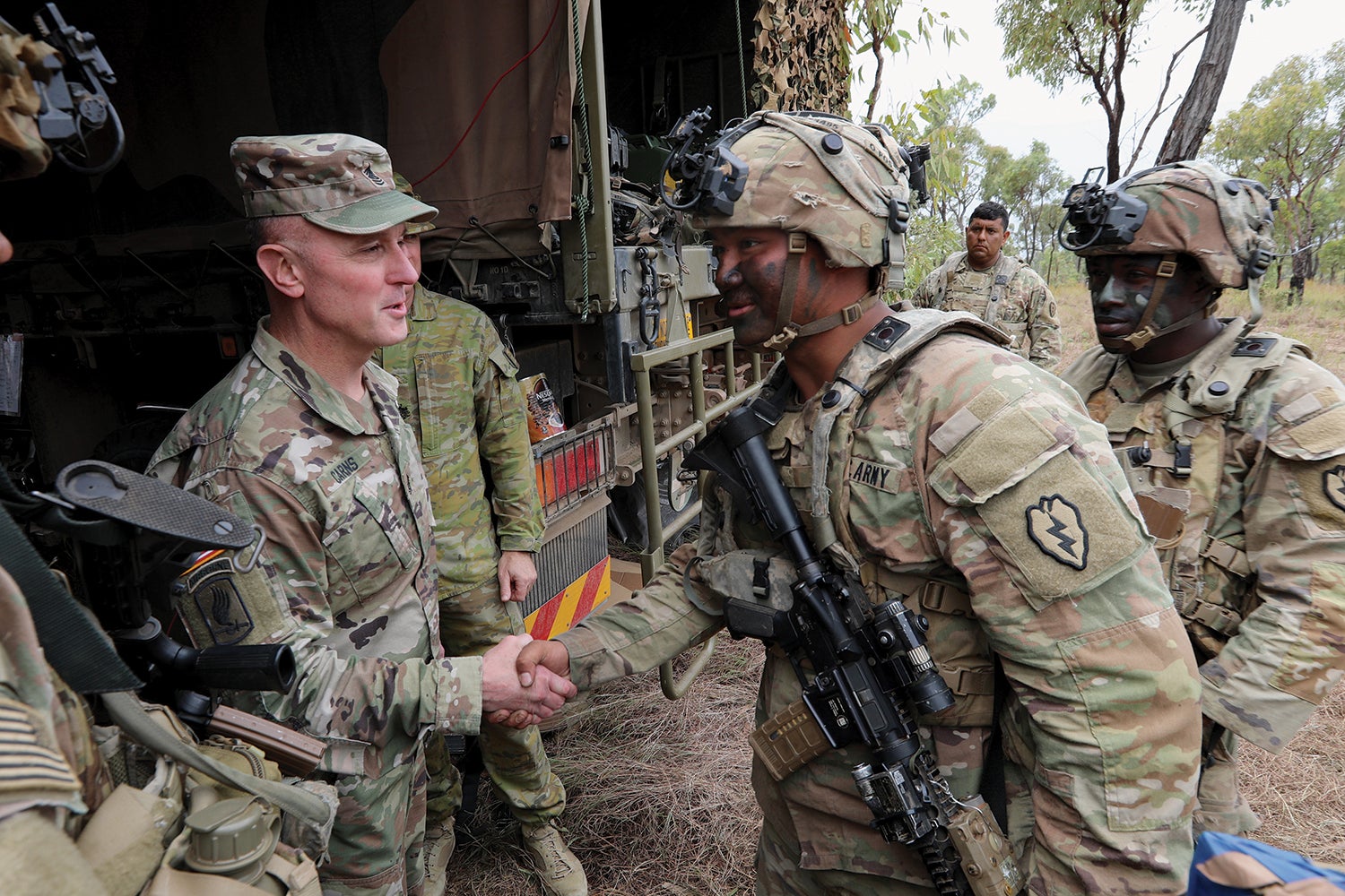 I Corps Command Sgt. Maj. Shawn Carns, left, visits 25th Infantry Division soldiers in Queensland, Australia, during exercise Talisman Sabre 23. (Credit: U.S. Army/Sgt. 1st Class John Healy)