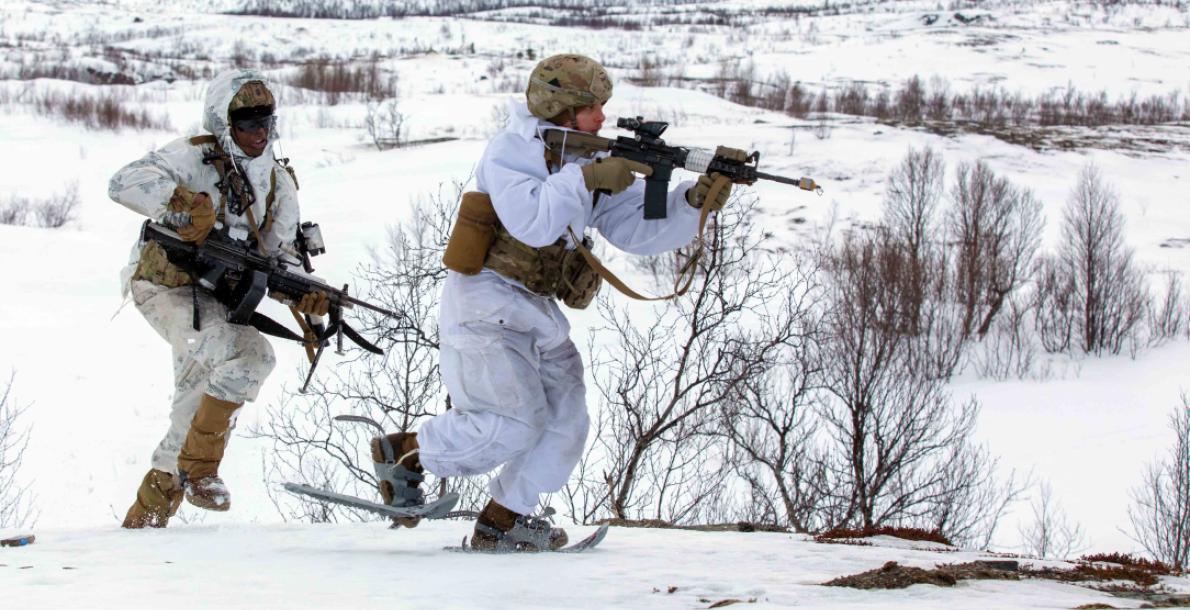 two soldiers running in the snow