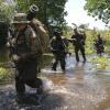 Soldiers with the 2nd Brigade Combat Team, 25th Infantry Division, and an Indonesian soldier patrol along a river during a joint exercise in Indonesia. (Credit: U.S. Army/Staff Sgt. Alex Manne)