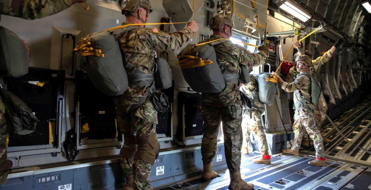 U.S. Army Soldiers with the 165th Quartermaster Company, 78th Troop Command, Georgia Army National Guard, wait for their turn to conduct static line airborne jumps out of a C-17 Globemaster III cargo airplane