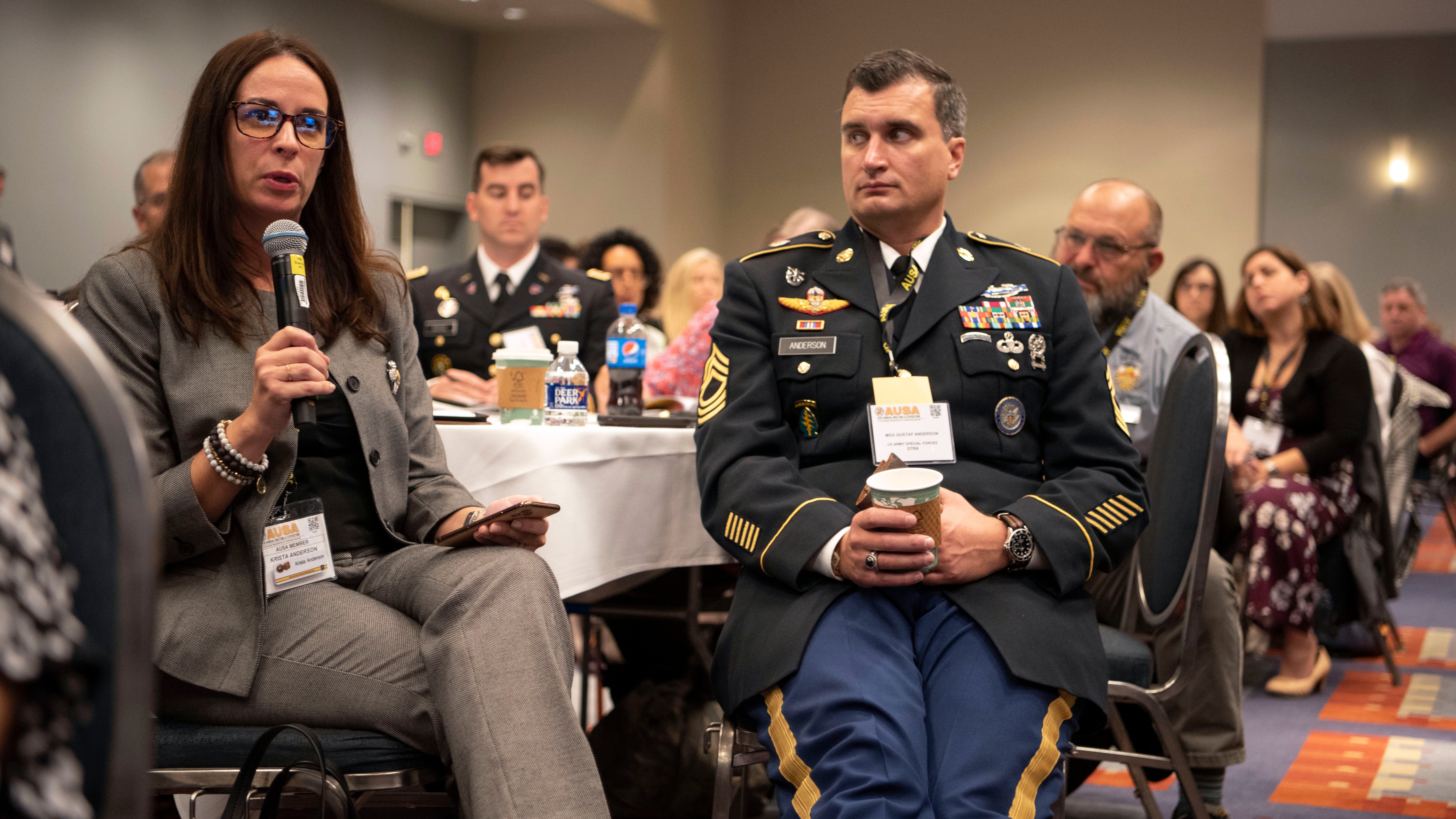 With her husband, MSG Gustav Anderson by her side, Krista Anderson asks a question to the panel at the Family Forum II: Army Housing and PCS at the 2019 AUSA Annual Meeting and Exposition at the Washington Convention Center on Oct. 15, 2019.