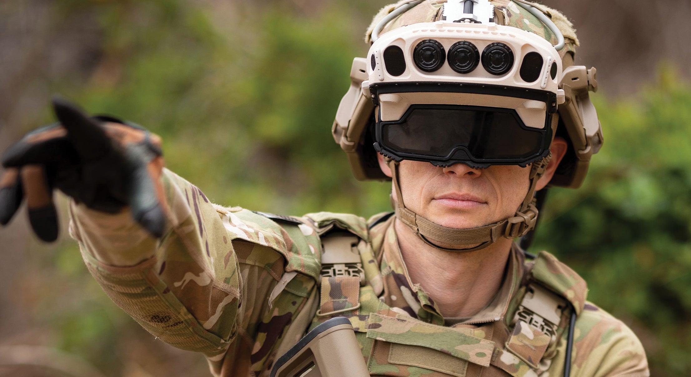 U.S. Army soldier wearing an IVAS 1.2 visor and pointing
