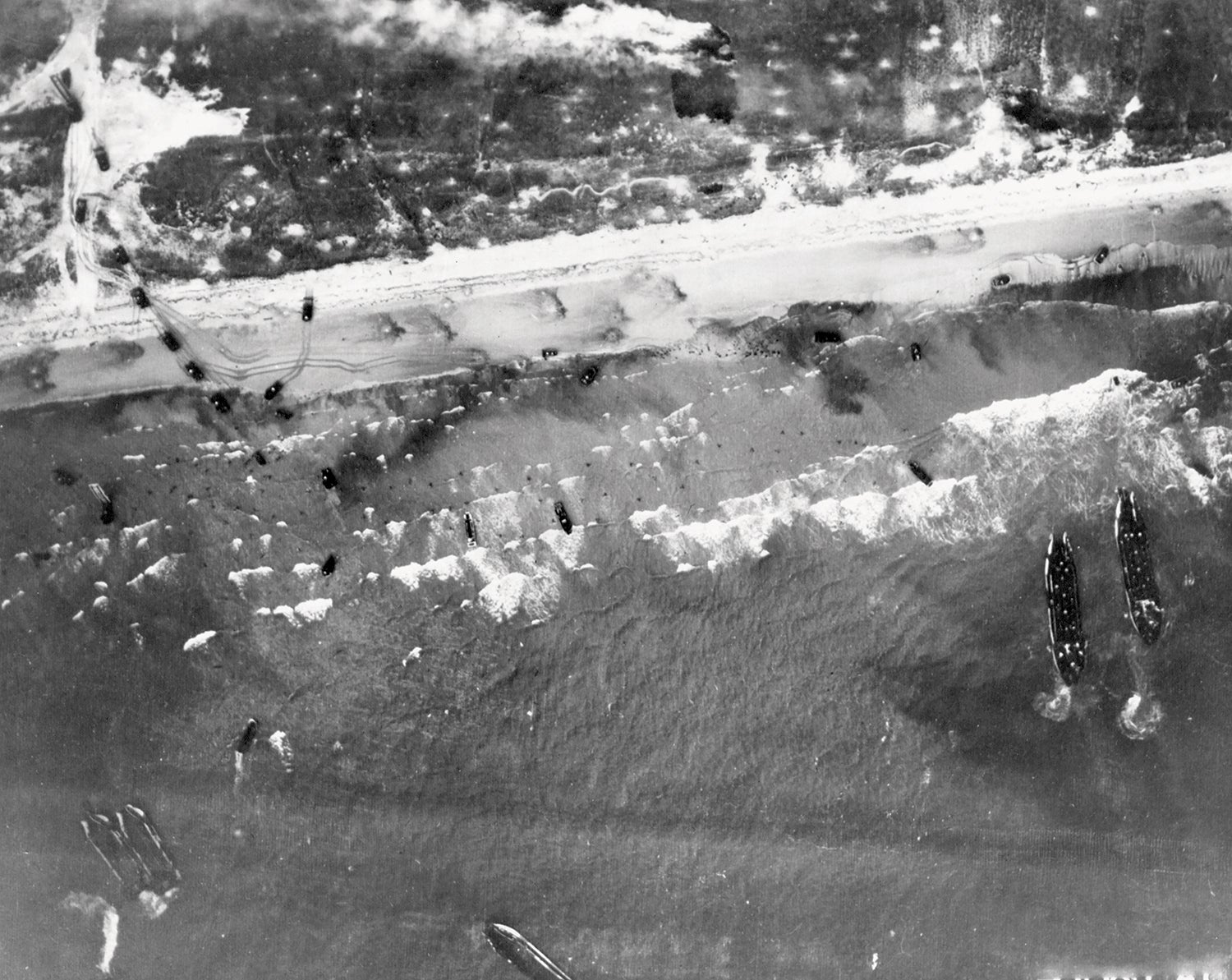 An aerial photograph shows the assault on the Normandy beaches of France on D-Day, June 6, 1944. (Credit: National Archives/U.S. Air Force)
