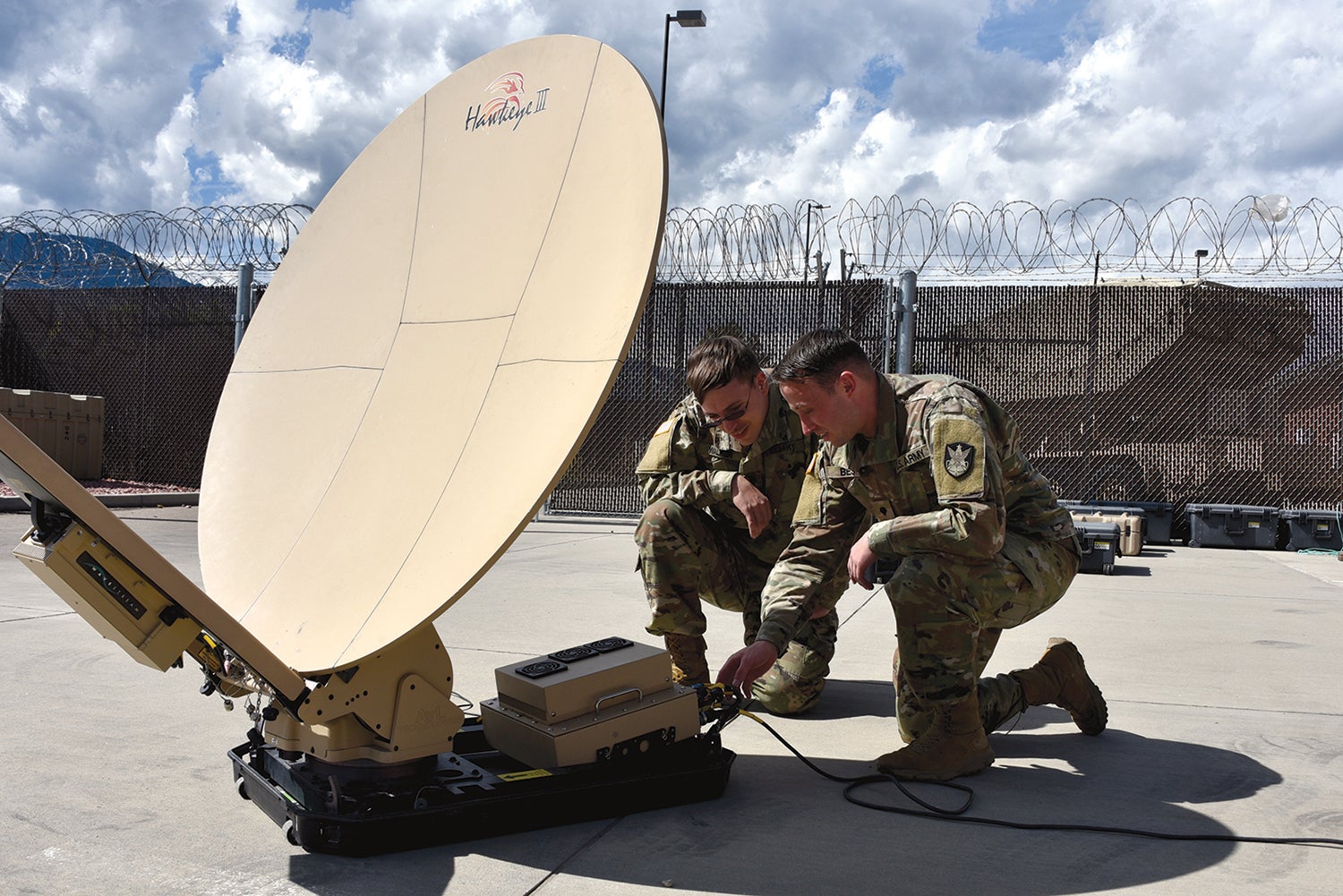 Spcs. Klay Walker, left, and Alexander Best with the 1st Space Battalion work with a 1.2-meter Hawkeye antenna at Fort Carson, Colorado. (Credit: U.S. Army/Dottie White)