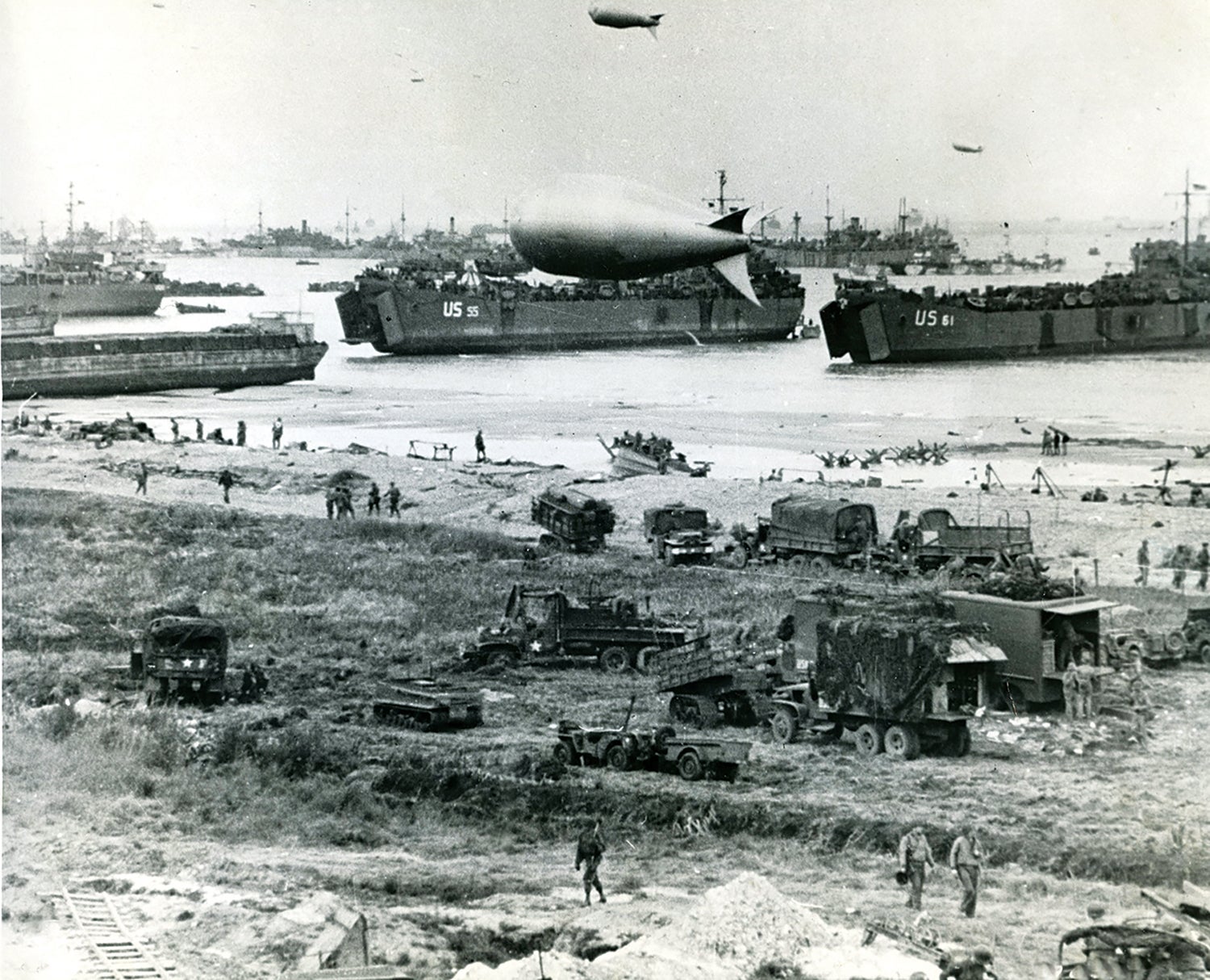 Clockwise from top: Supplies are brought ashore on the Normandy, France, beachhead on D-Day, June 6, 1944. (Credit: National Archives)