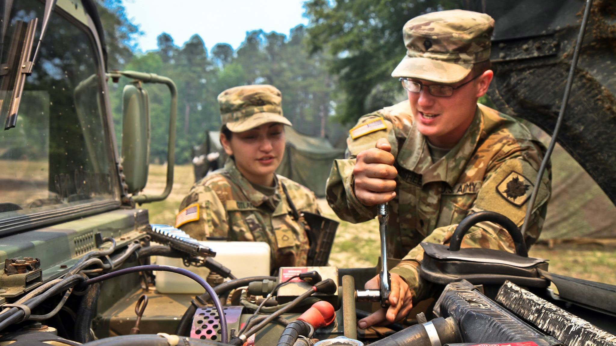 Soldiers maintaining equipment