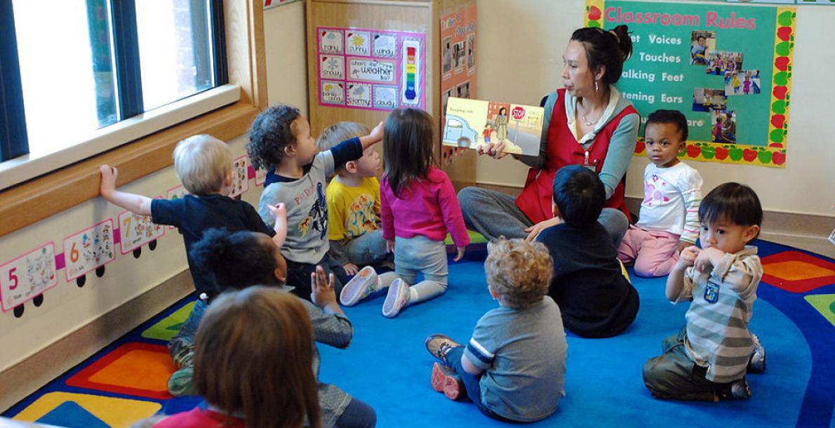An Army installation employee reads to children
