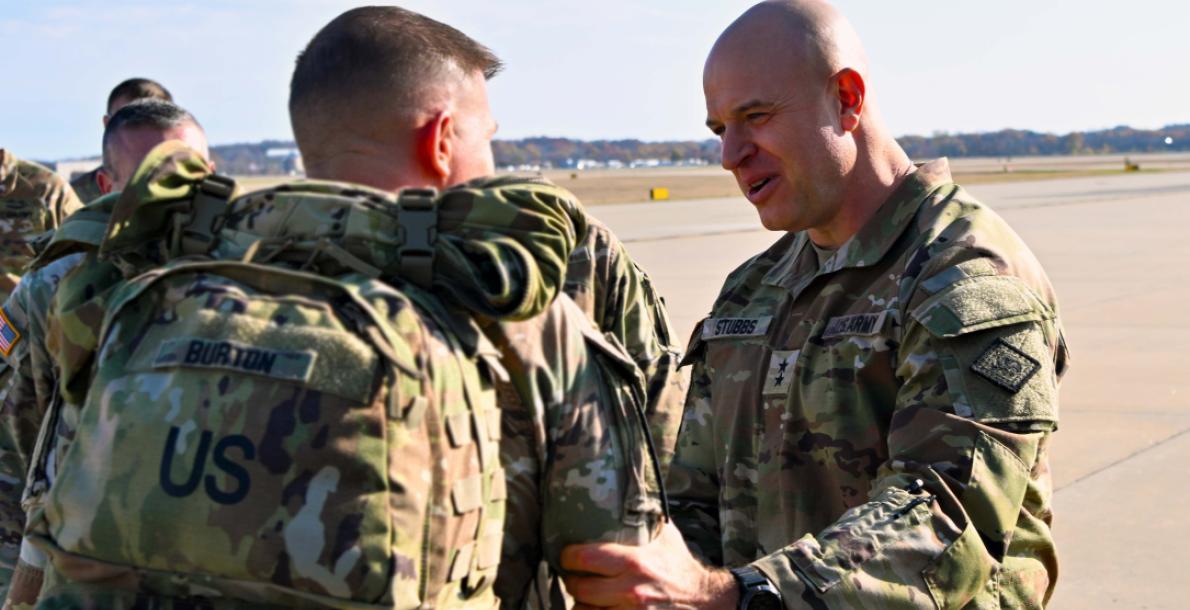 Maj. Gen. Jonathan Stubbs greets returning Guardsmen planeside before they are reunited with their families.