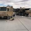 Two heavily damaged M1120A4 trucks